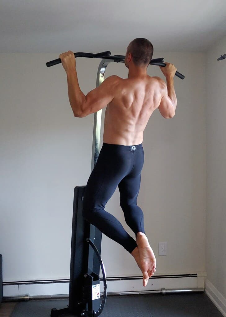Compact home gym setup with pull-up and strength equipment for a demanding home workout plan